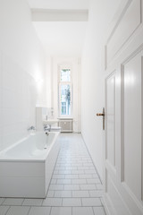 Fototapeta na wymiar White bathroom - tiled bath with bathtub