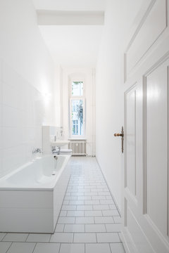 White bathroom - tiled bath with bathtub