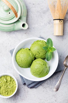 Green tea matcha ice cream scoop in white bowl. Copy space. Top view