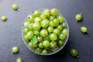 Fresh gooseberries in glass bowl. Top view.