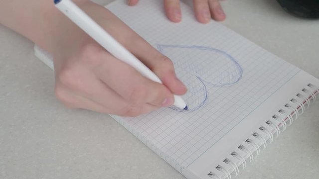 Drawing a heart on a piece of paper