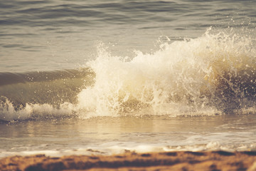 Waves breaking sand beach