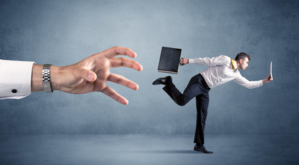 Businessman running from hand