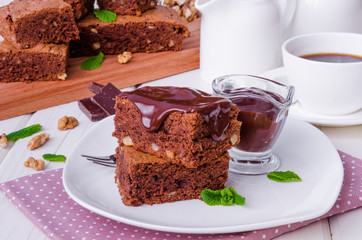 Chocolate cake brownie with walnuts and chocolate sauce