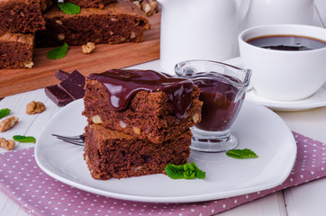 Chocolate cake brownie with walnuts and chocolate sauce