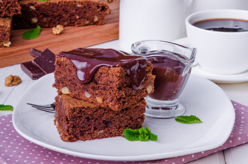 Chocolate cake brownie with walnuts and chocolate sauce
