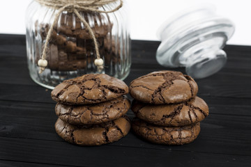 Black Brownie Cookies on a black table and glass jar