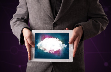 Fototapeta na wymiar Businessman holding tablet with cloud graphic