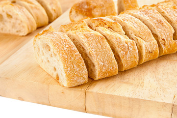 Sliced french baguette closeup on wooden background