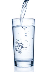 Pouring water into glass on white background