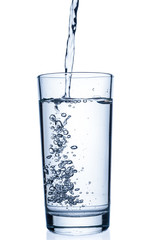 Flowing pure water into tumbler on white background