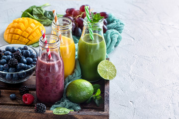 Colorful detox smoothie in bottles, summer diet fresh drink for breakfast or snack.