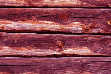 pink toned log house wall.