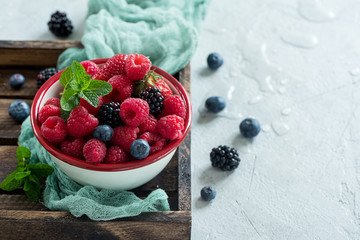 Fresh summer berries, raspberry, blueberry, blackberry in a bowl, raw vegan eating
