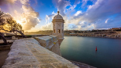 Senglea, Malta - Watch tower at Fort Saint Michael, Gardjola Gardens at sunset with beautiful sky...