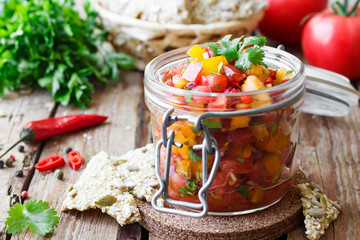Tomato salsa with chili in a glass jar