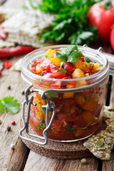 Tomato salsa with chili in a glass jar