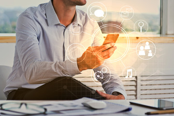 Businessman using smartphone with business diagram