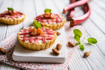 Almond tartlets filled with curd and topped with rhubarb