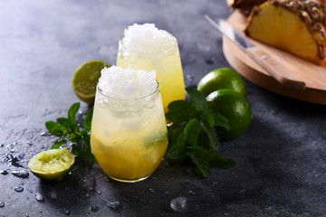Cold pineapple cocktail with crushed ice, lime and mint, refreshing lemonade drink - 148961412