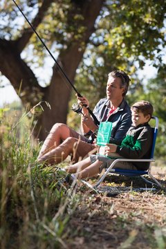 Father and son fishing in forest