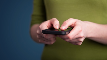 Young woman holding smarthphone in hand