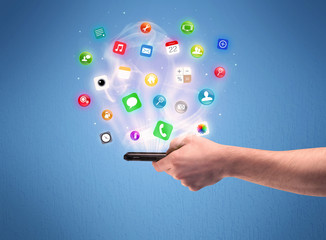 Hand holding tablet phone with app icons