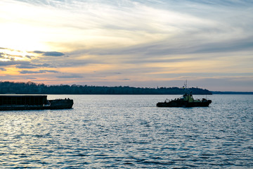 Obraz premium The tug pulls the barge 