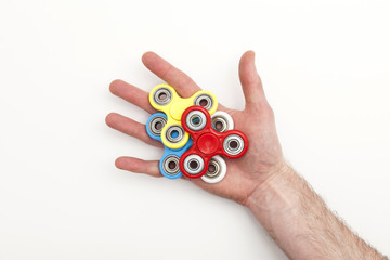 Male hand holding popular fidget spinner toy
