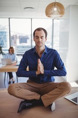 Executive meditating on desk