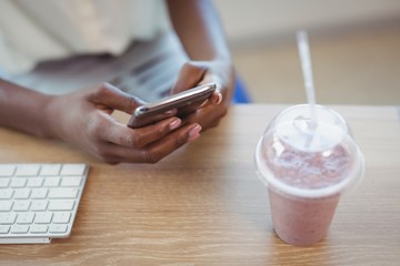 Executive using mobile phone at desk