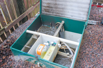 Opened the septic tank to check its functionality. Outdoor Septic Tank. Clogged Septic tank, is full. The water leaves the septic tank..