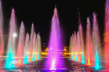 colored water fountain at night
