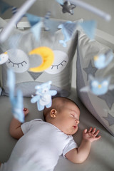 baby boy white t-shirt sleeping in a round bed