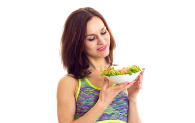 Sportive woman holding salad 