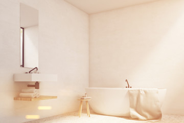 White bathroom with sink and tub, toned