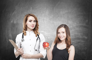 Doctor and woman with apple