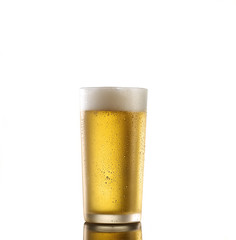 Fresh beer in a glass on a white background. The concept of food.