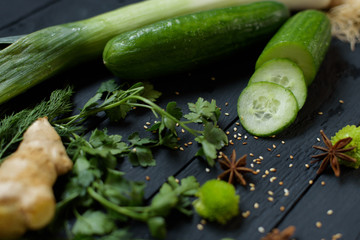 Vegetables ginger lime avocado cut in two pisces cucumber parsley leeks on wooden background