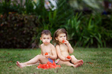 Little boy and girl eat watermelon. Summer, food, picnic, outdoor.