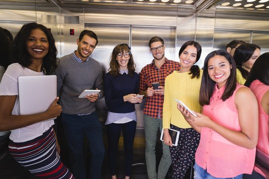 Portrait Of Business People Standing In Elevator