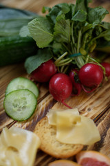 Vegetables ginger lime avocado cut in two pisces cucumber parsley leeks cheese croutons toast on wooden background