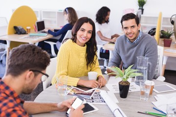 Portrait of business people at desk