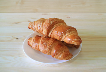Fresh whole wheat Croissant pastries served on natural light color wooden table 