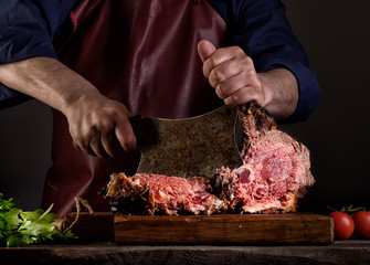 Man is cutting a grilled beef
