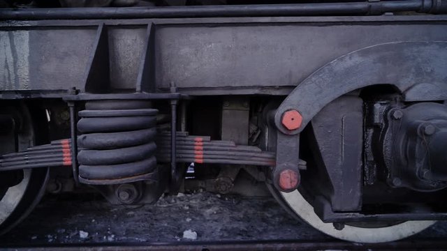 Close-ups of steel diesel railcar train bogie wheels starting on the tracks.