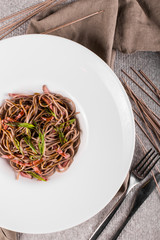 Bowl of soba noodles with beef and vegetables. Asian food. Top view