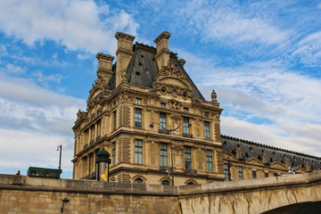 Fototapeta na wymiar View on Louvre museum building, blue sky with white clouds, paris city, france