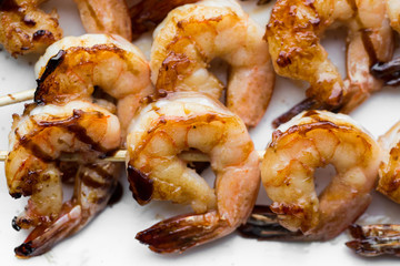 tasty spiced shrimp skewers on a barbecue