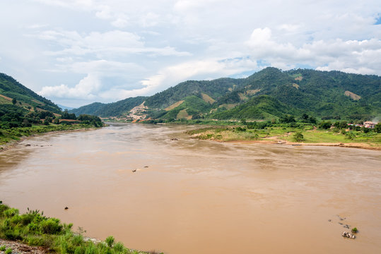 Natural landscape of Mekong River is a muddy color flowing through the mountains, is the border between Thailand and Laos photo is taken in Chiang Rai Province, Thailand